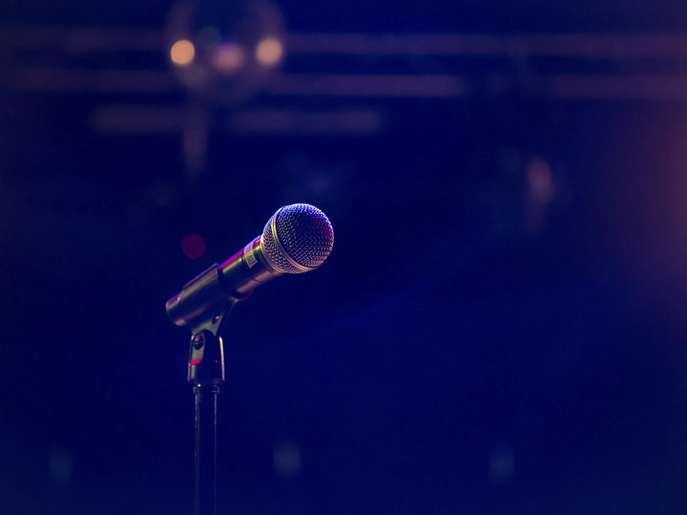 A fado singer performing under warm low light